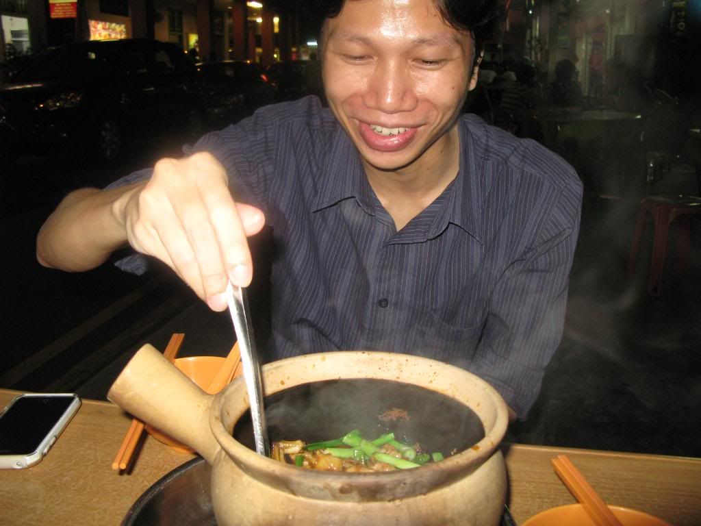 Foo & Frog Legs My host, Foo, digging into a claypot filled with frogs. Yum! *ribbit